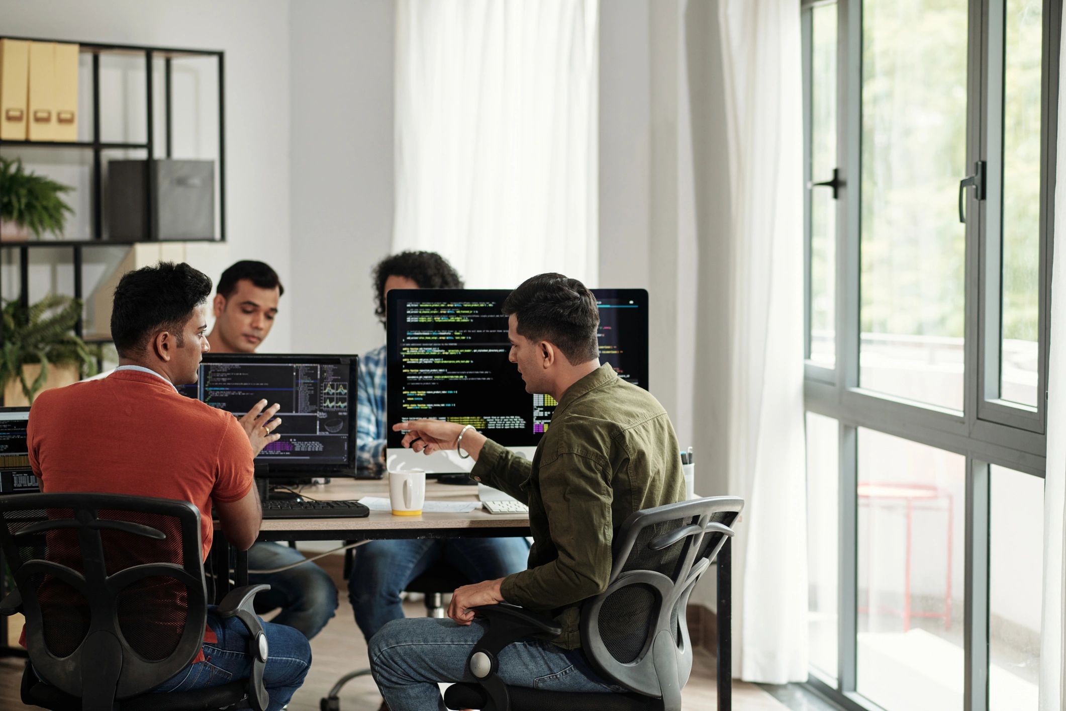 Developers discussing programming code together